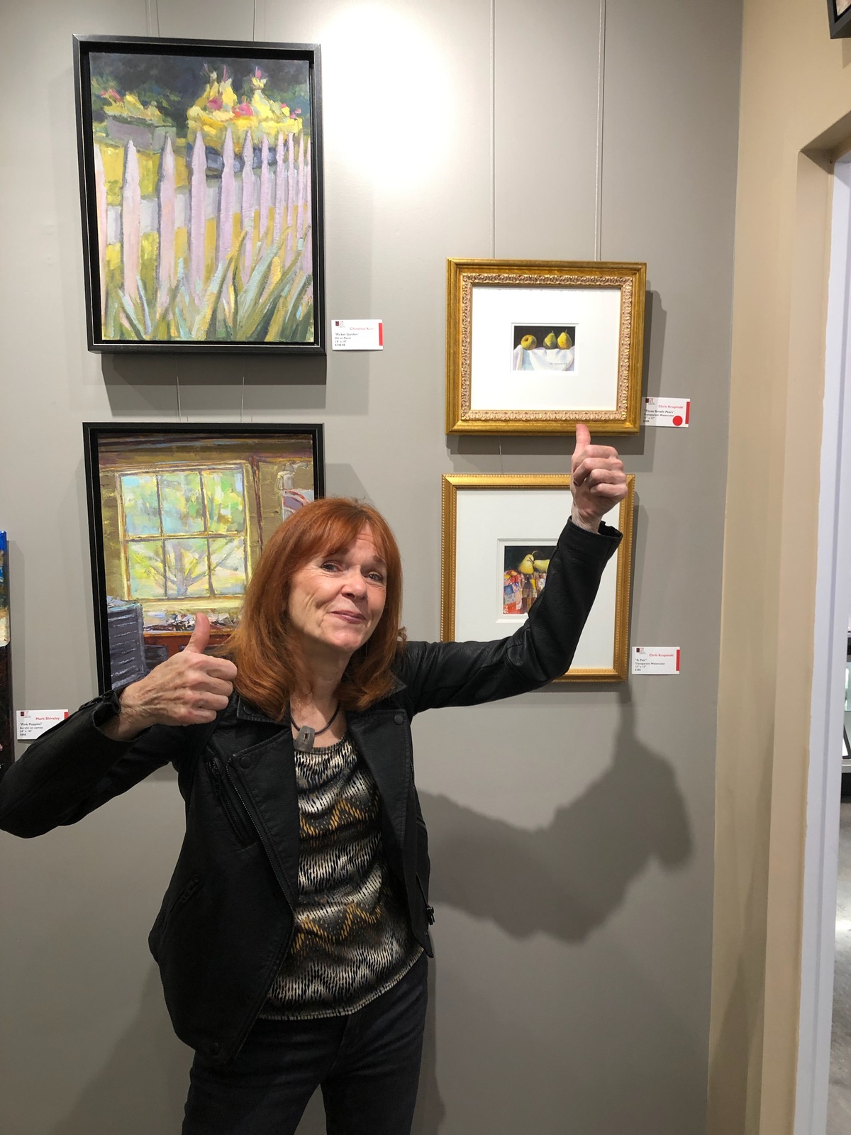 Chris Krupinski in front of her sold watercolor painting
